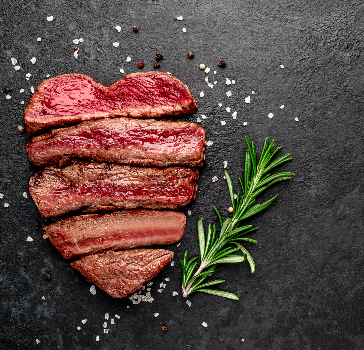 A heart-shaped steak with rosemary